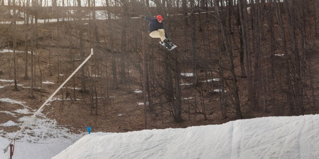 Snowboarder above hip jump